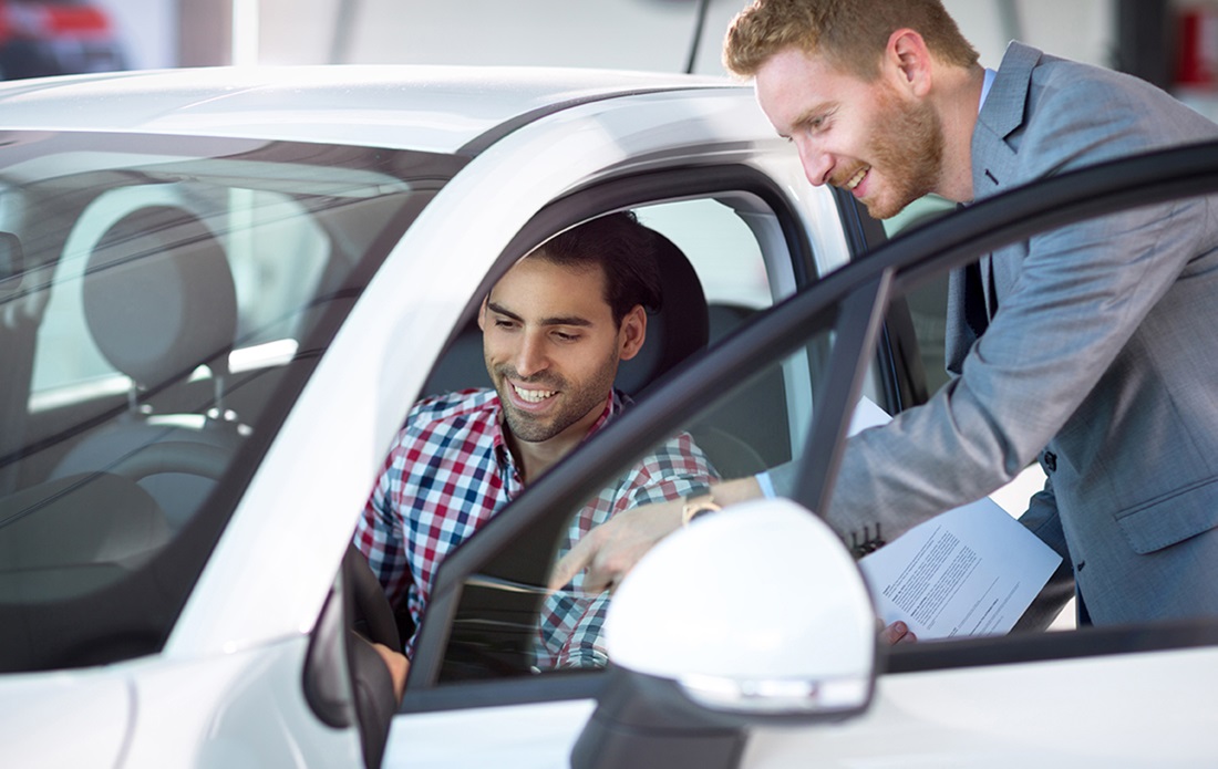 Two men discussing rental car details