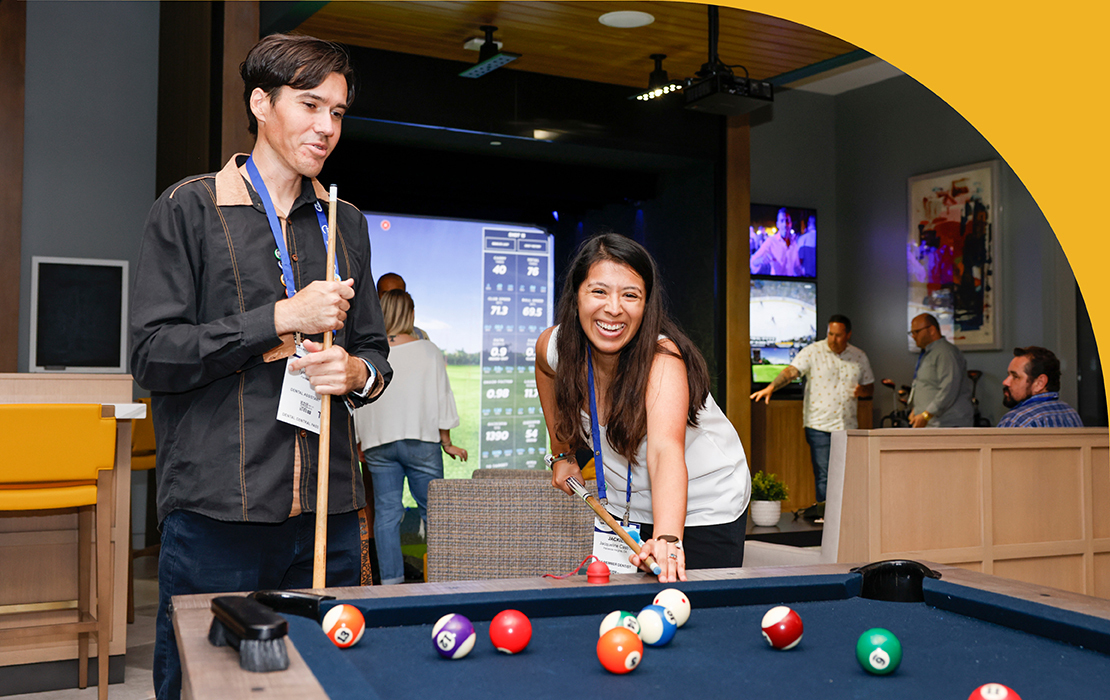 SmileCon attendees at the New Dentist Reception playing billiards