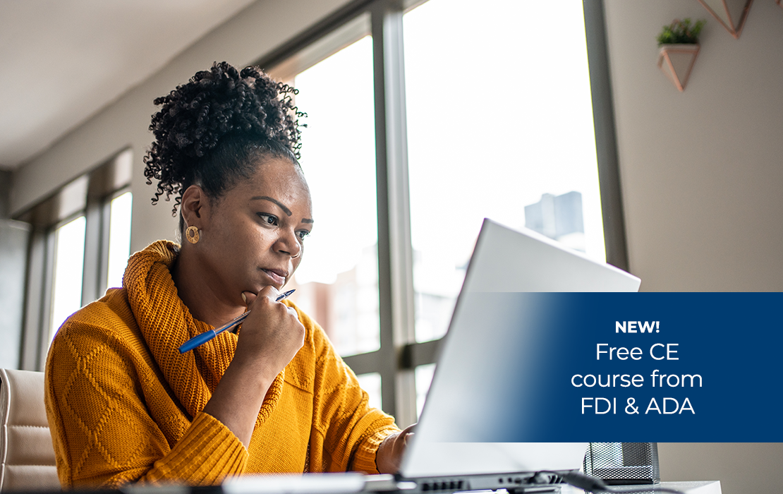 A woman looking at her computer for a Free CE course from FDI & ADA
