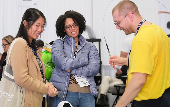 Two participants watching a demonstration