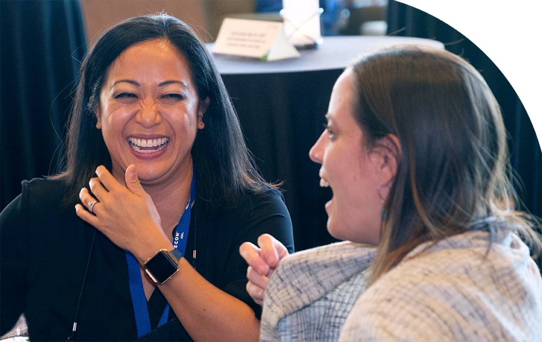 Two women having a great time at a SmileCon.