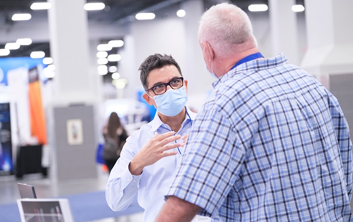SmileCon 2021 exhibitor sharing information with attendee