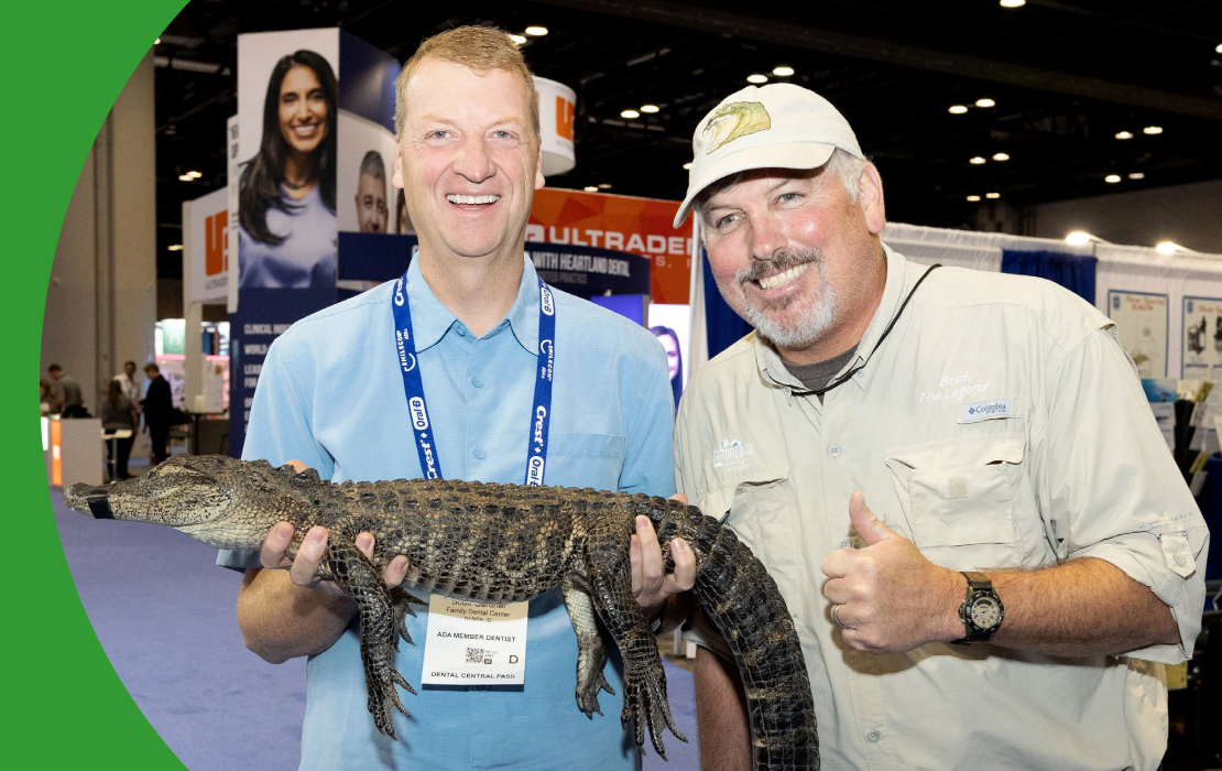 SmileCon attendees posing with a small aligator in Dental Central