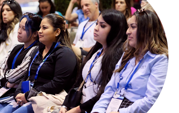 A team is engaged and listening during a Smilecon session