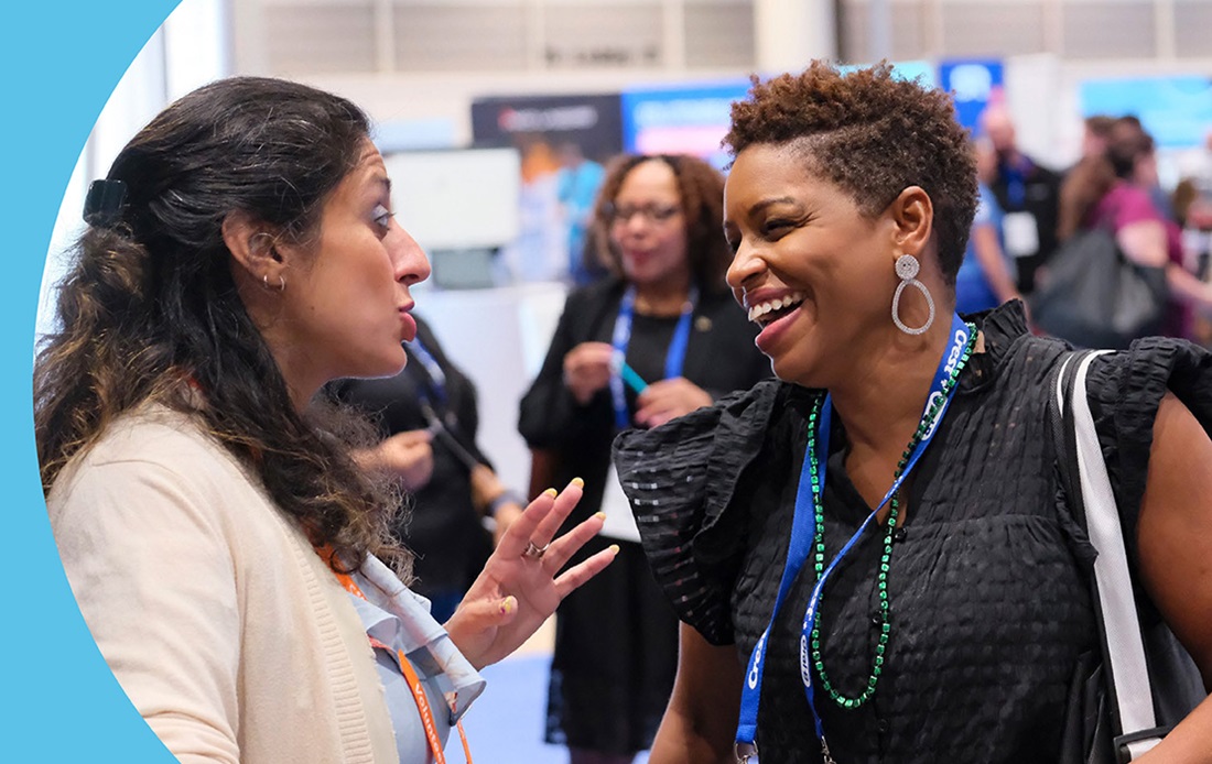 Two woman attendees talking