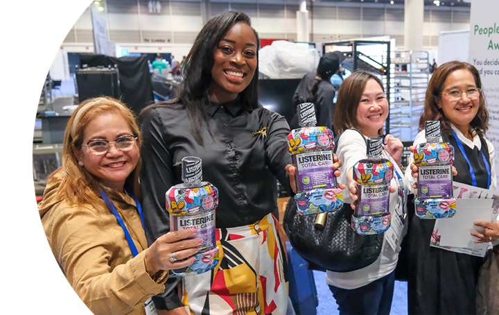 Attendees holding up Listerine TotalCare