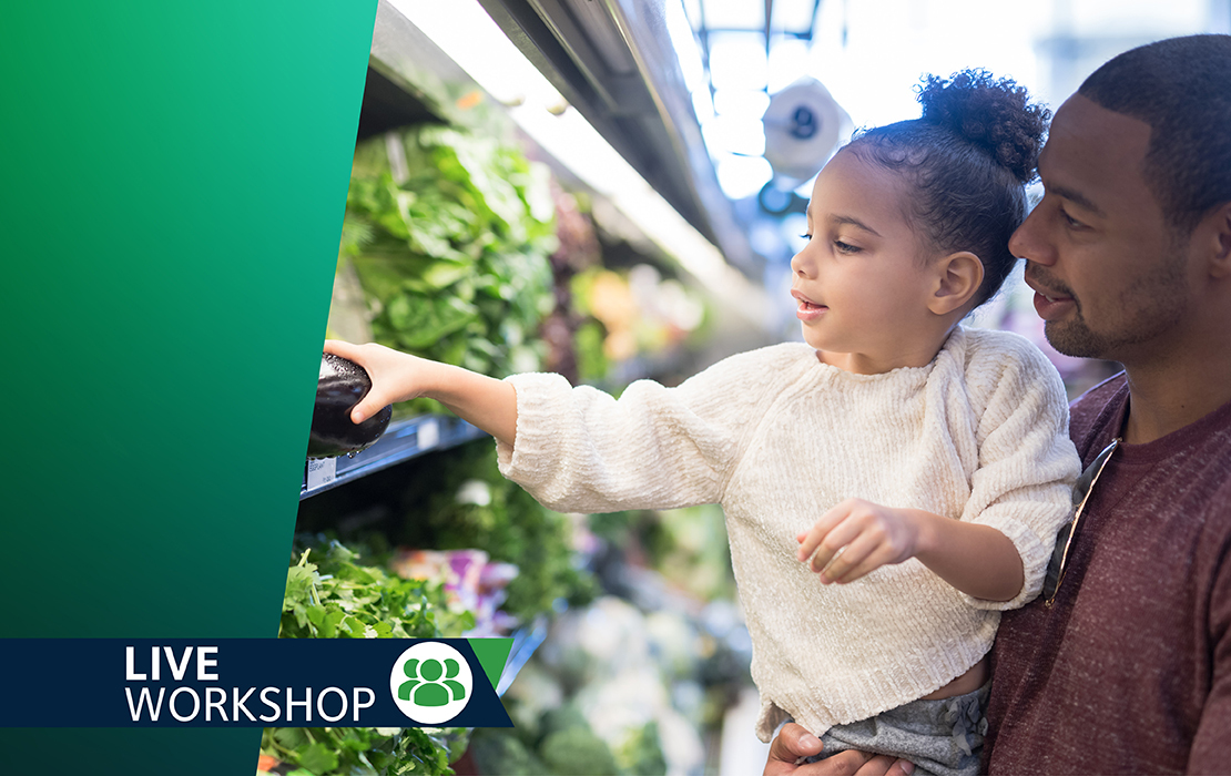 Dad holding daughter in produce aisle