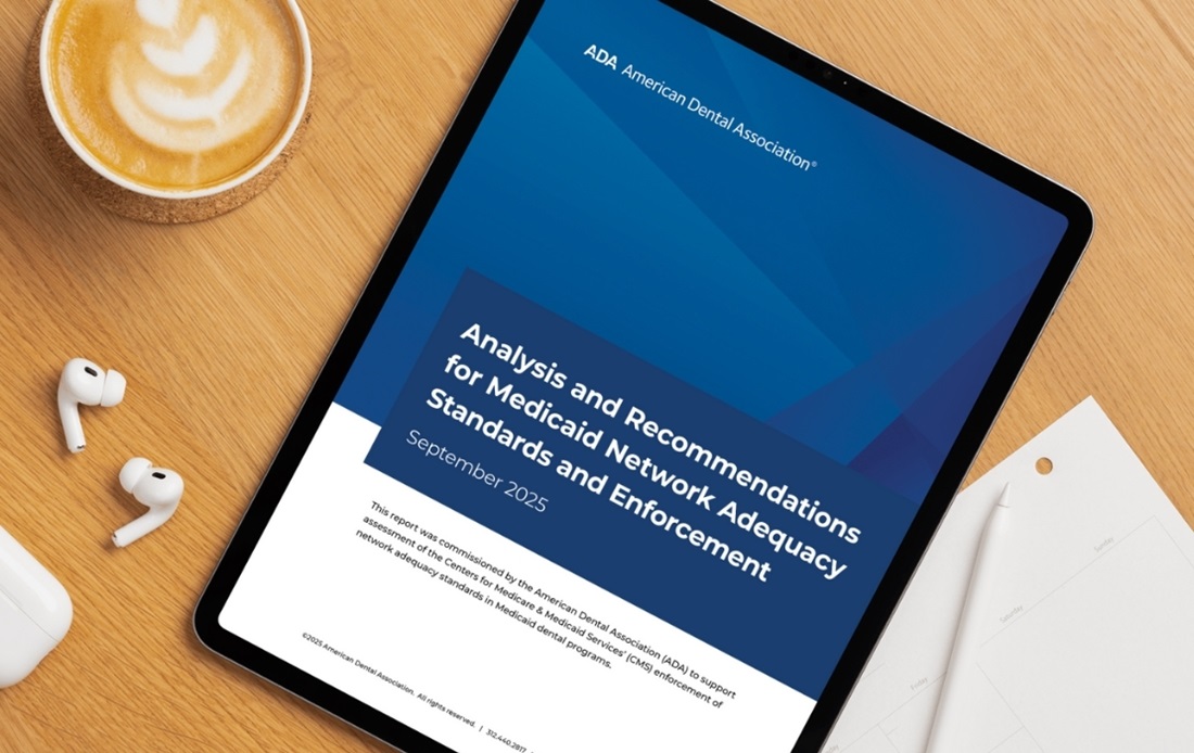 Medicaid info on a tablet, ear buds, latte