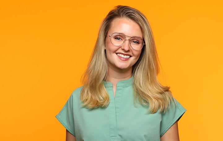 Female dentist wearing green scrubs