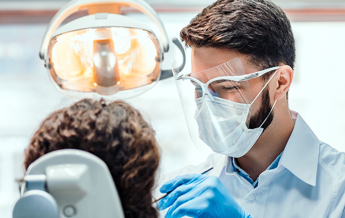 A photograph of a dentist examining a patient.