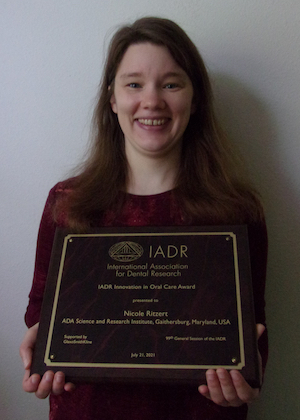 Photo of Nicole Ritzert, Ph.D., with award