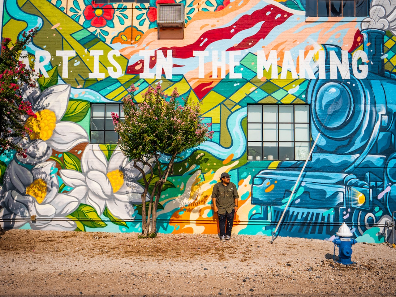 Photo of Houston artist David Maldonado with mural
