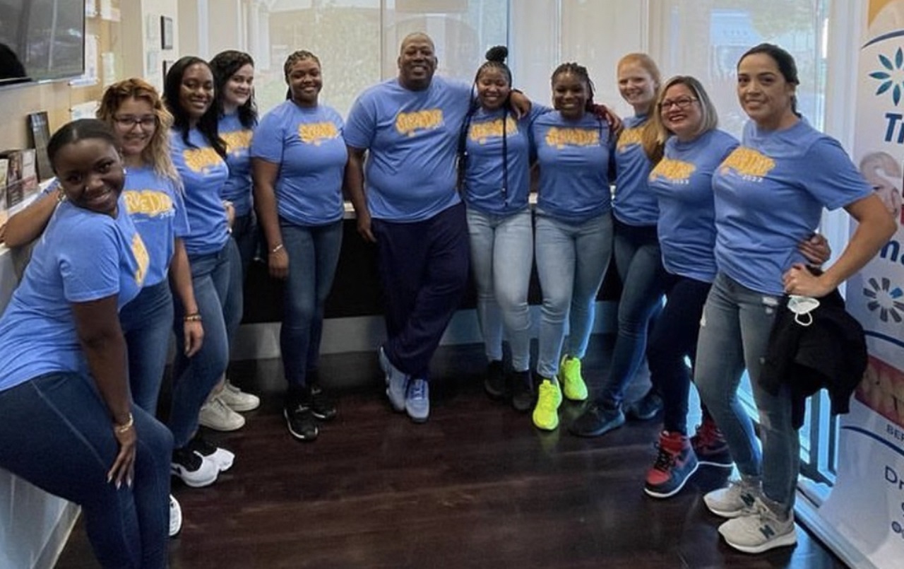 Photo of Dr. Joshua Golden and the West Sunrise Dentistry team in Miami as they huddle up for Smile Generation Serve Day.