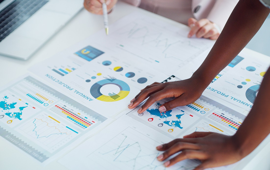 Hands resting atop data that is being analyzed