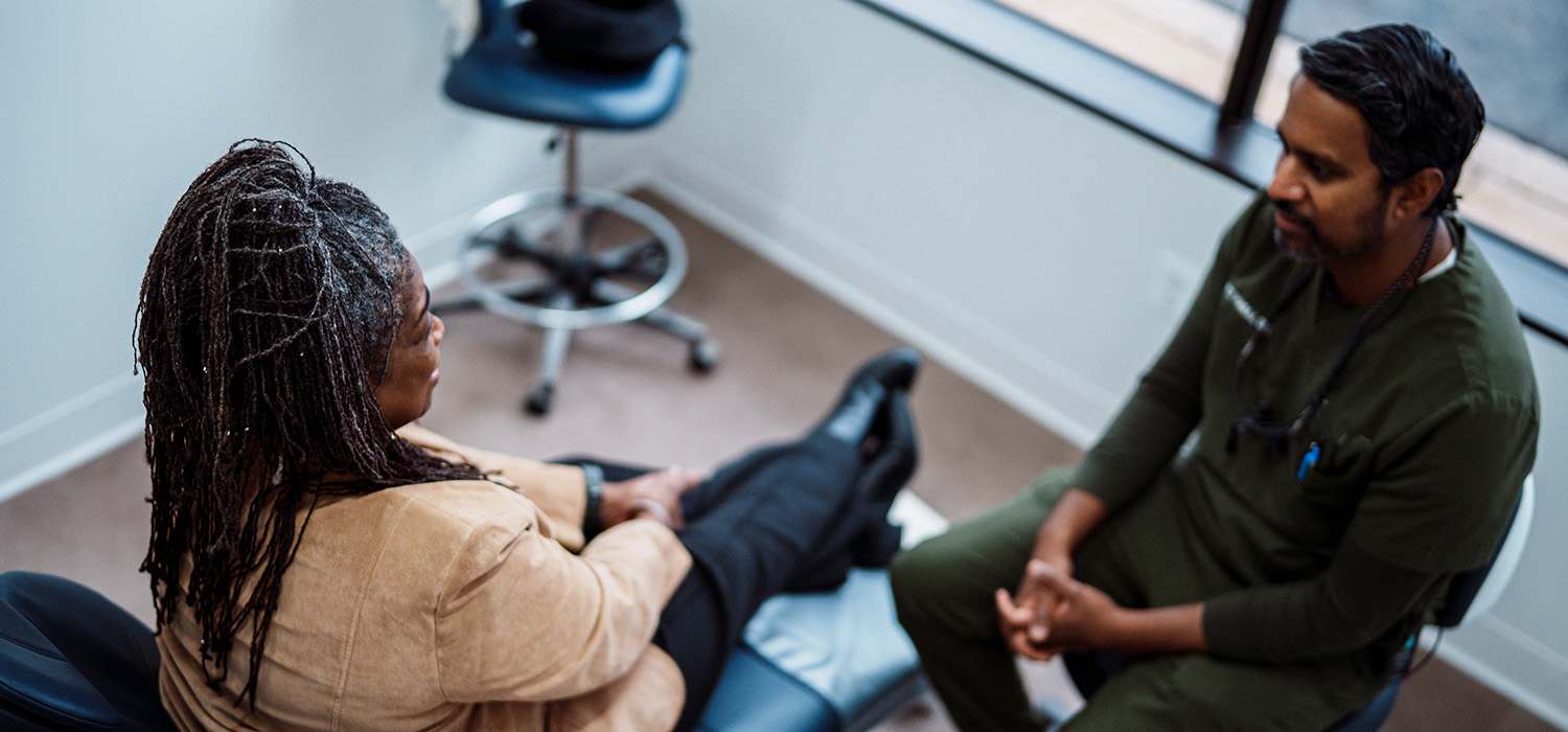 Dentist talking to patient