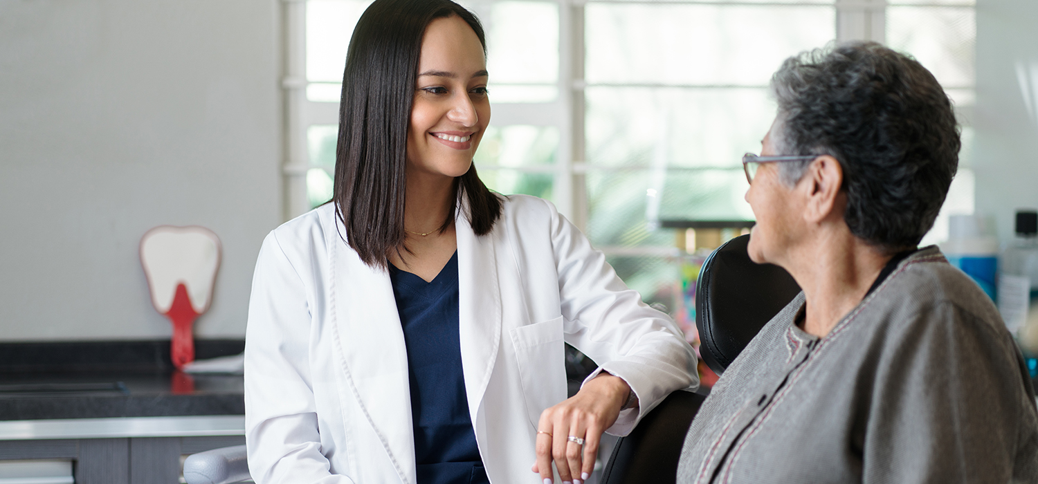 Dentist talking to menopausal woman