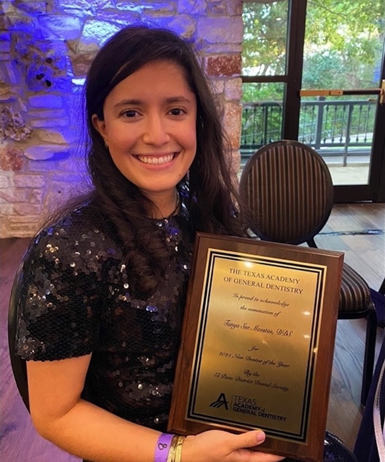 Photo of Tanya Sue Maestas, D.D.S., with award