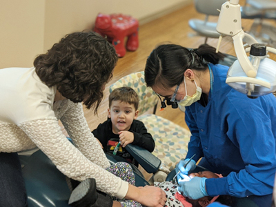 Photo of Dr. Greene attending her kids’ dental visit