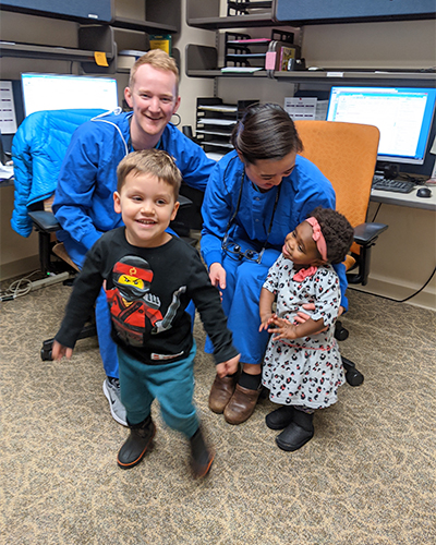 Photo of Dr. Greene’s kids with her coworkers