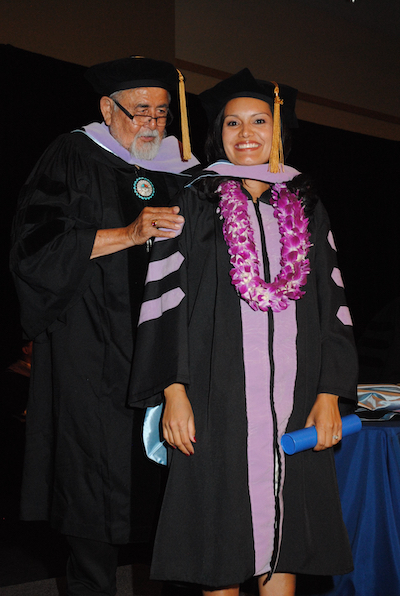 Dr. George Blue Spruce during Dr. Lisa Begay's hooding ceremony in 2014