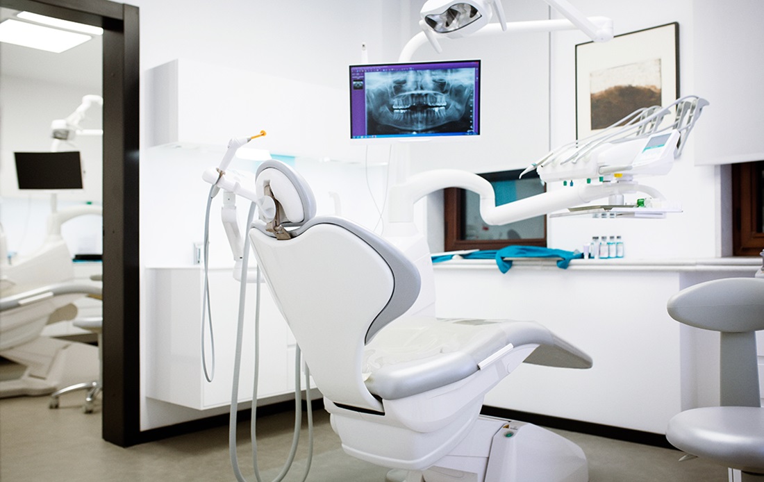 A photograph of a modern dental chair and office.