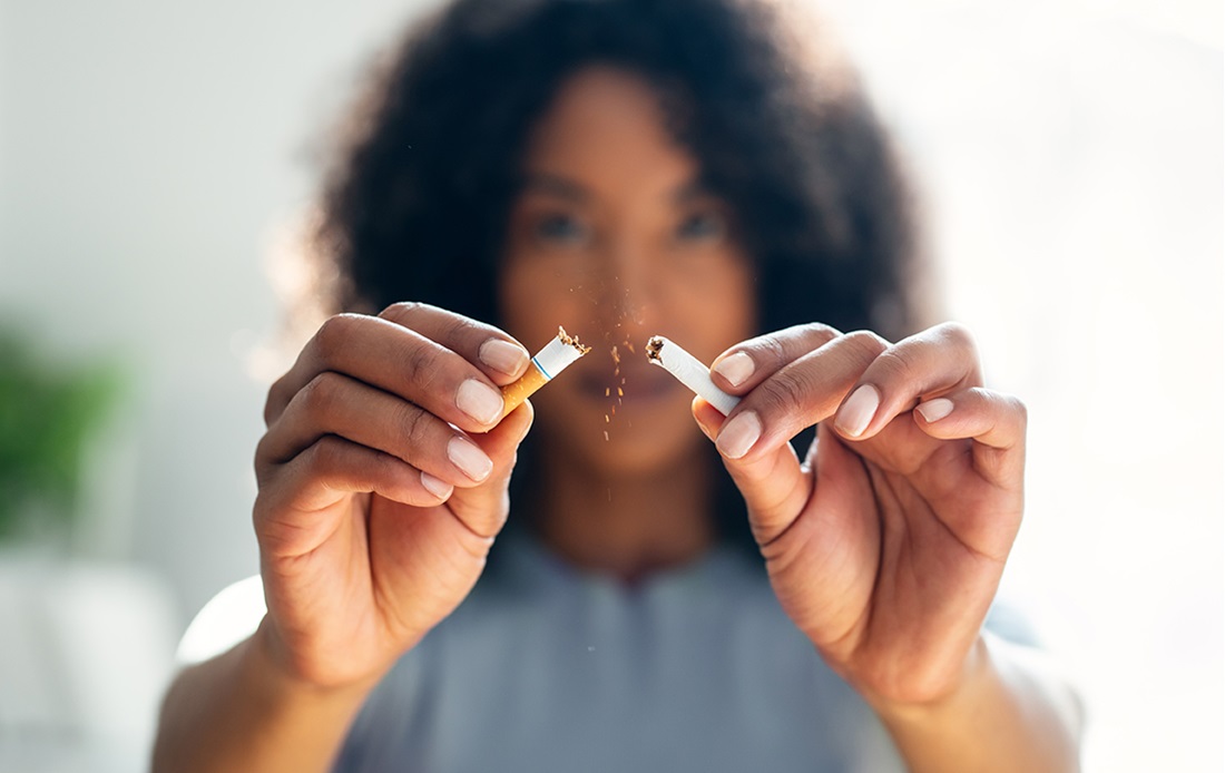Woman breaking up a cigarette