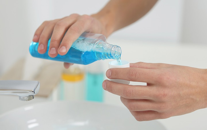 Someone pouring mouth rinse