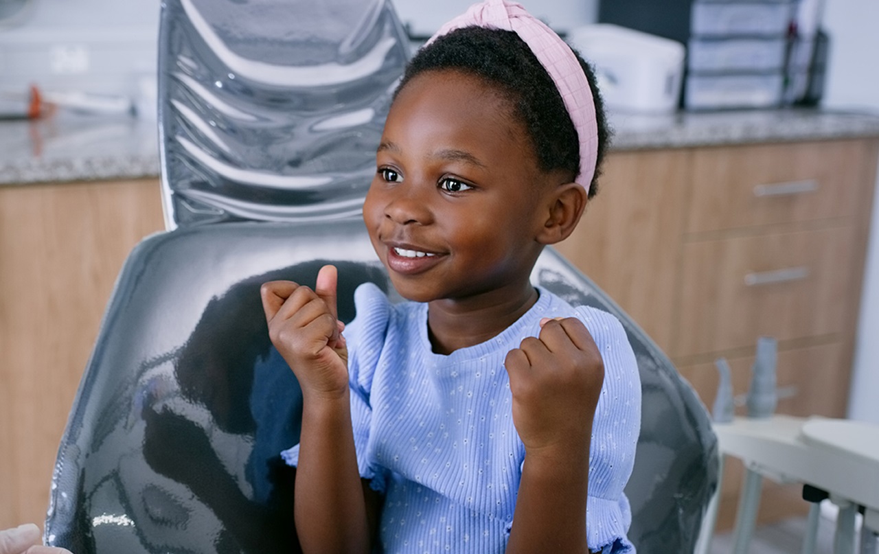 Child sitting up in dentist chair