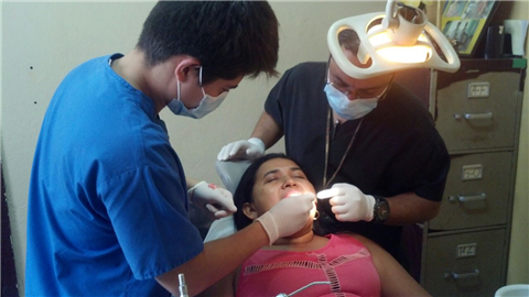 Clinicians treating patient in overseas clinic