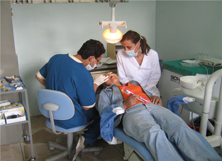 Clinicians treating patient in chair