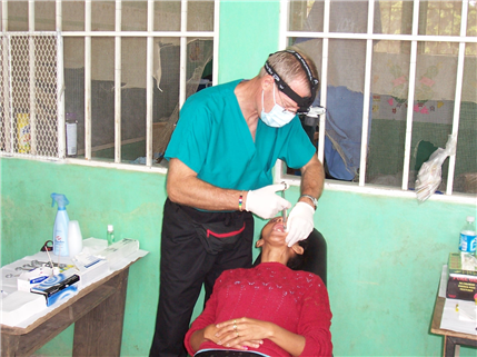Dentist performing procedure on patient