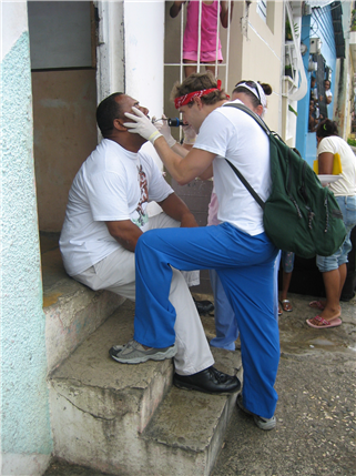 Dentist examining patient on steps outside building