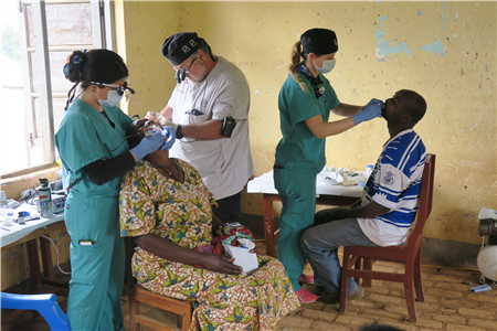Dentists working on patients in Ugandan clinic