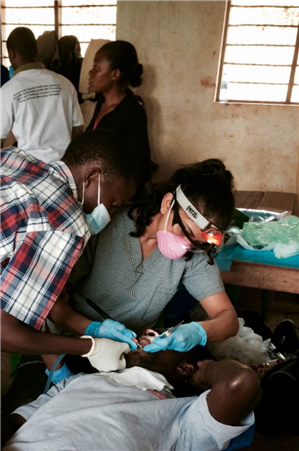 Dentist and assistant extracting tooth
