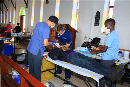 Dentists treating patients in rural clinic