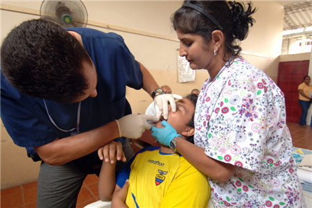 dentist holding child's mouth open