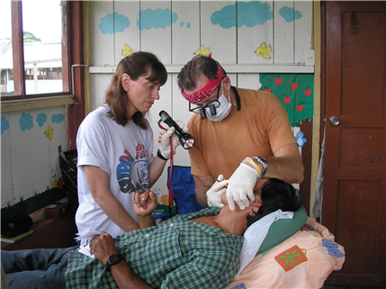 Dentist and assistant examining patient 