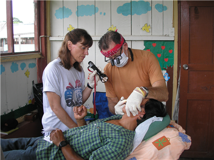 Dentist and assistant examining patient