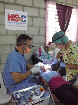 Dentist and assistant treating patient