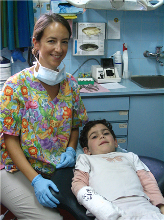 Feamle dentist with young boy