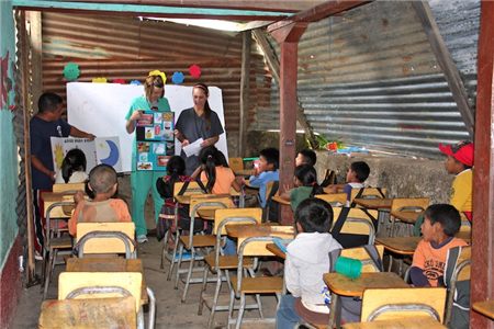 Instructors teaching children in classroom