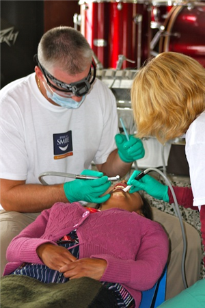Dentists examining girl