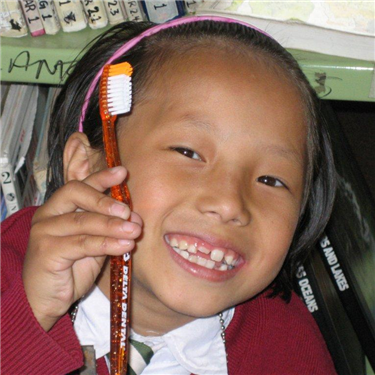 Small girl holding toothbrush
