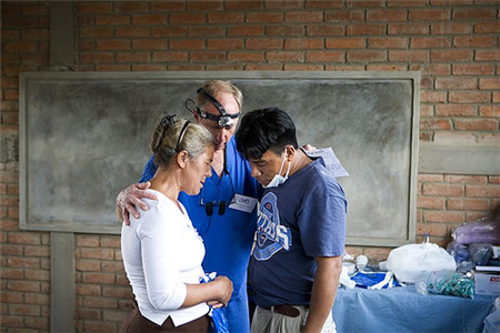 dentist standing with two patients
