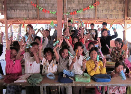 Young children holding toothbrushes