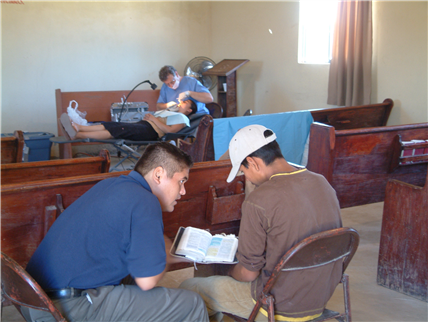 View of dental clinic with a patient receiving care in the background