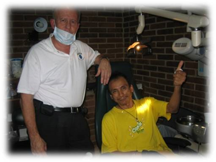 Dentist with patient chair showing thumbs up