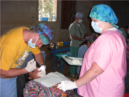 Dentist extracting tooth of woman