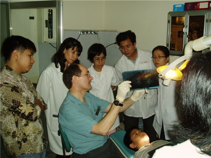 Dentist poiting to xray showing local professionals