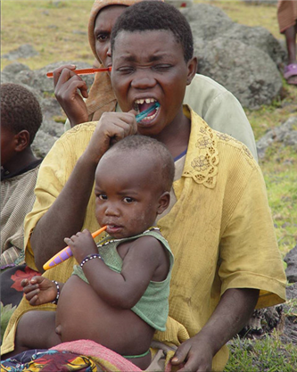 African mother and child brushing teeth